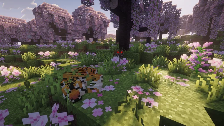 An orange-striped tiger resting among pink blossoms under a dark tree, with a red-eyed creature watching from behind.