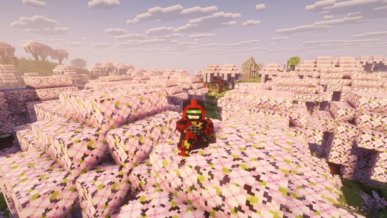 A player character sitting atop pink and white blossom-covered hills, with buildings in the distance.