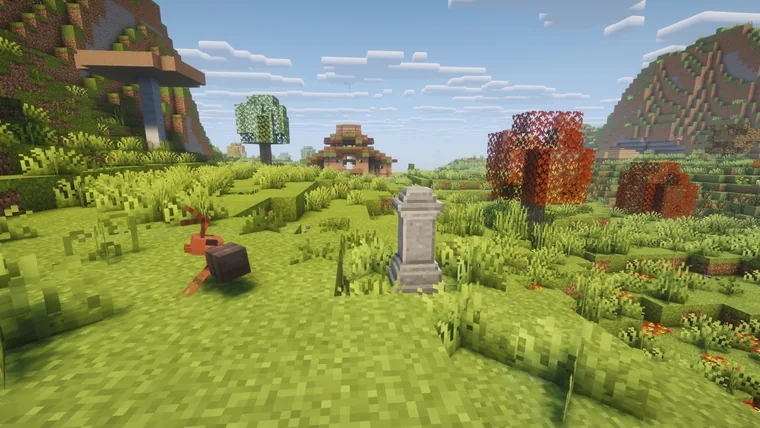 An orange crab-like creature in grass near a stone monument and a small wooden shrine, with red autumn trees and mountains behind.