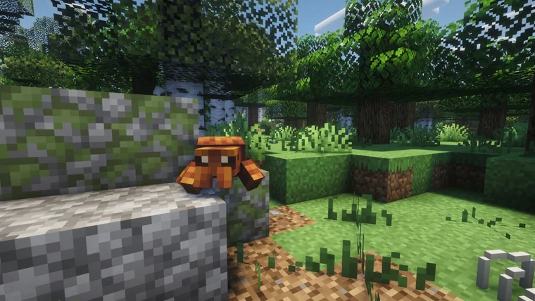 An orange crab-like creature perched on a rocky stone ledge in a forest.