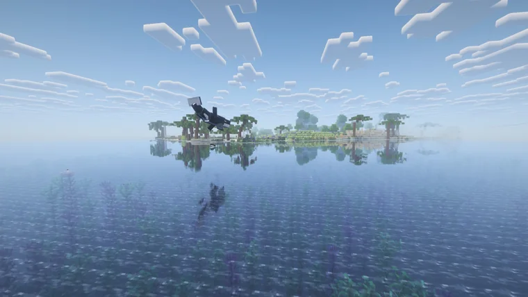 A small palm-tree island reflected in calm water at sunrise, with a black and white bird flying overhead.
