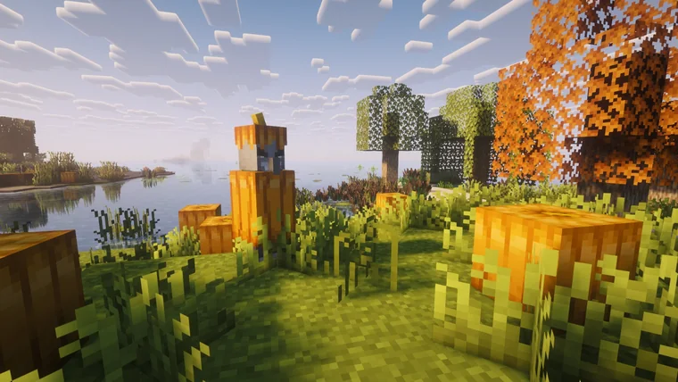 Pumpkin-topped wooden totems on a lake shore among autumn-orange trees.